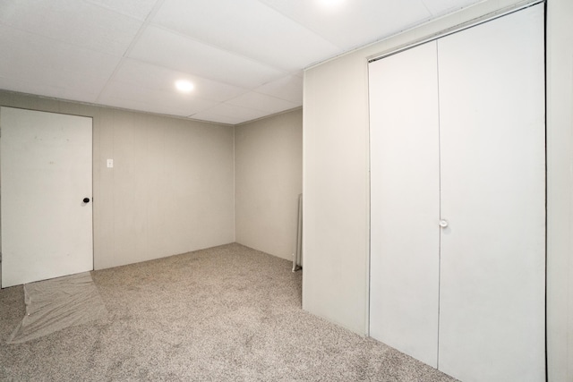 finished below grade area with carpet and a paneled ceiling