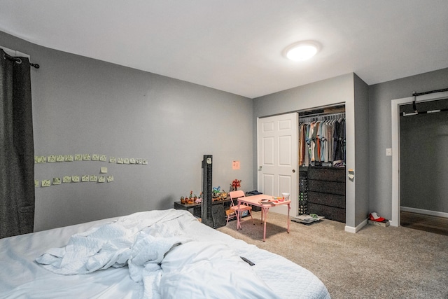 bedroom with carpet floors, a closet, and baseboards