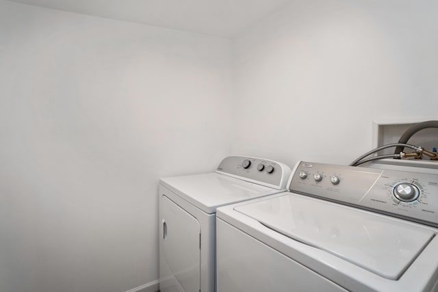 clothes washing area featuring washer and clothes dryer