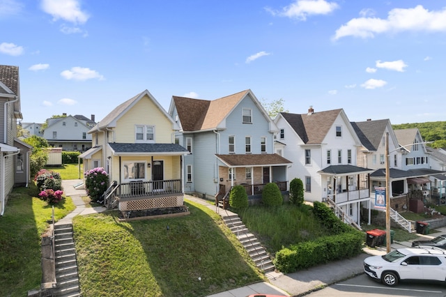 view of front of home with a residential view, stairs, and a porch