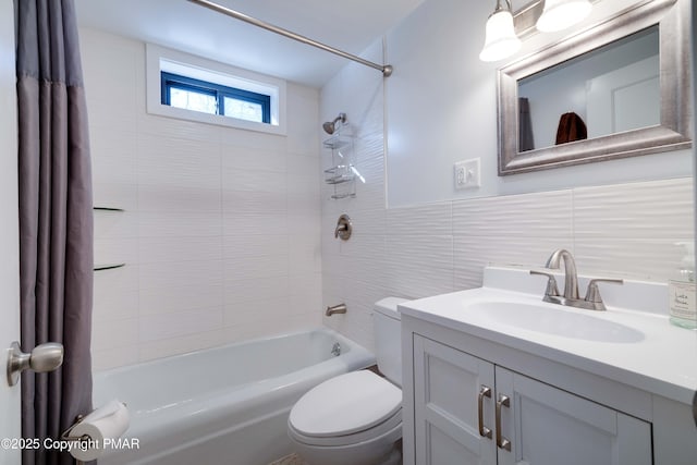 full bathroom featuring vanity, tile walls, shower / bathtub combination with curtain, and toilet