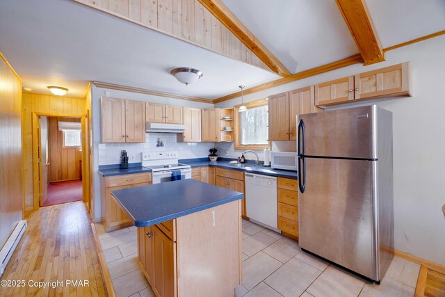 kitchen featuring sink, white appliances, a wealth of natural light, and a kitchen island