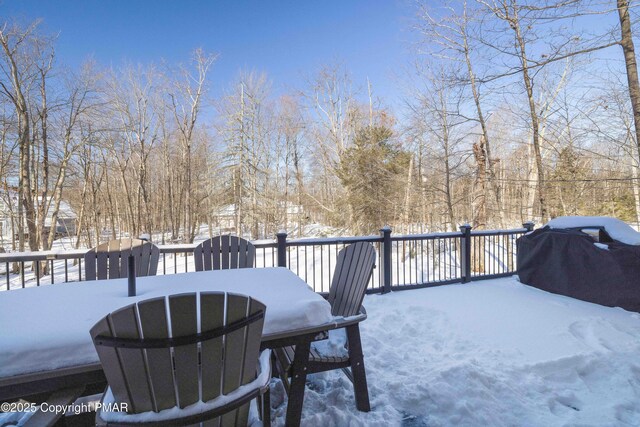 snow covered deck featuring area for grilling