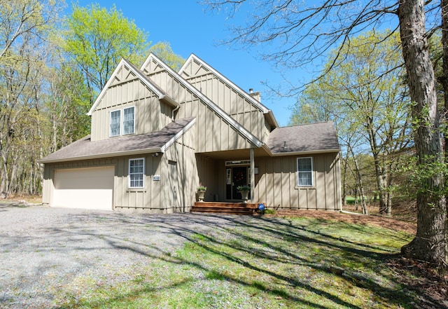 355 Windy Bush Rd, Pocono Pines, PA 18350 - view of front of house featuring board and batten siding, a chimney, gravel driveway, an attached garage, and roof with shingles