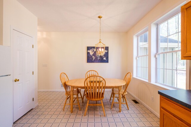 355 Windy Bush Rd, Pocono Pines, PA 18350 - dining space with a chandelier, plenty of natural light, baseboards, and light tile patterned floors