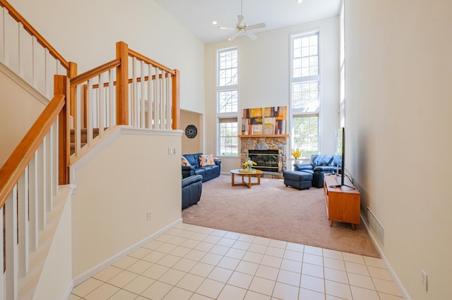 355 Windy Bush Rd, Pocono Pines, PA 18350 - living area with carpet floors, a high ceiling, stairs, a stone fireplace, and baseboards
