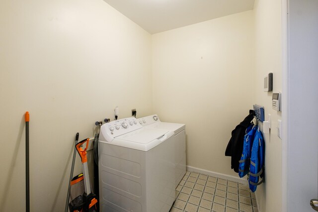 355 Windy Bush Rd, Pocono Pines, PA 18350 - washroom featuring separate washer and dryer, light tile patterned floors, and baseboards