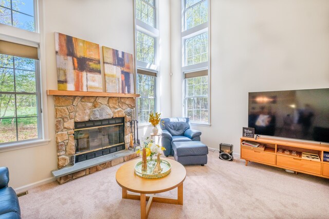 355 Windy Bush Rd, Pocono Pines, PA 18350 - carpeted living area with a high ceiling, plenty of natural light, and a fireplace