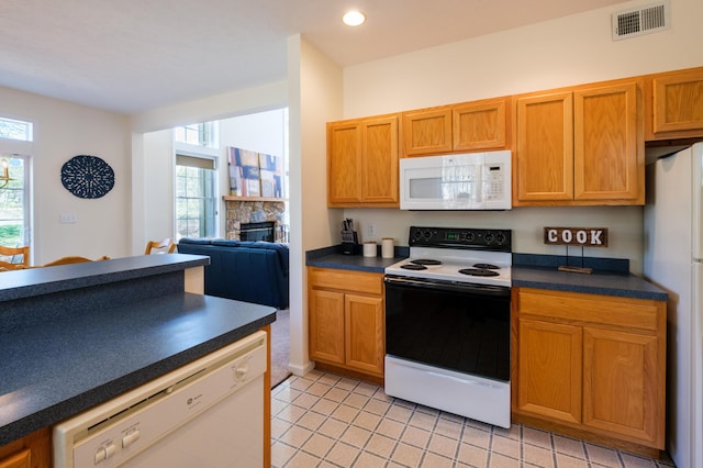 355 Windy Bush Rd, Pocono Pines, PA 18350 - kitchen featuring white appliances, dark countertops, healthy amount of natural light, a fireplace, and recessed lighting