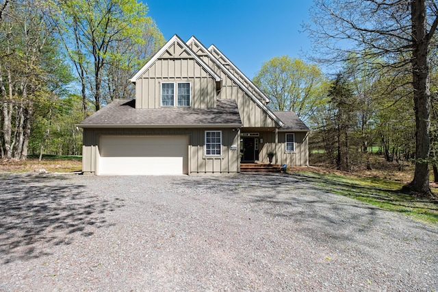 355 Windy Bush Rd, Pocono Pines, PA 18350 - view of front of house featuring board and batten siding, driveway, an attached garage, and a shingled roof