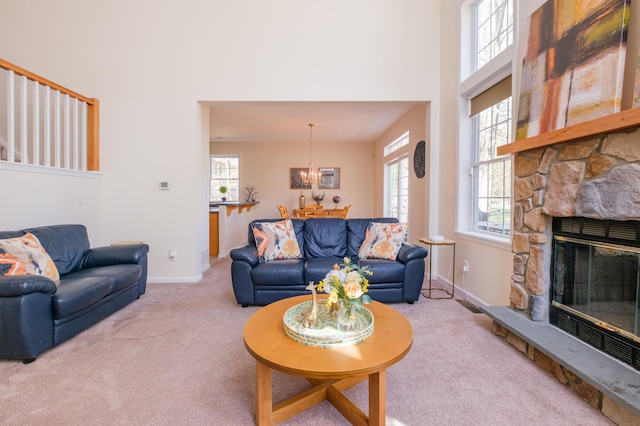 355 Windy Bush Rd, Pocono Pines, PA 18350 - living room with carpet flooring, a high ceiling, baseboards, a fireplace, and a chandelier