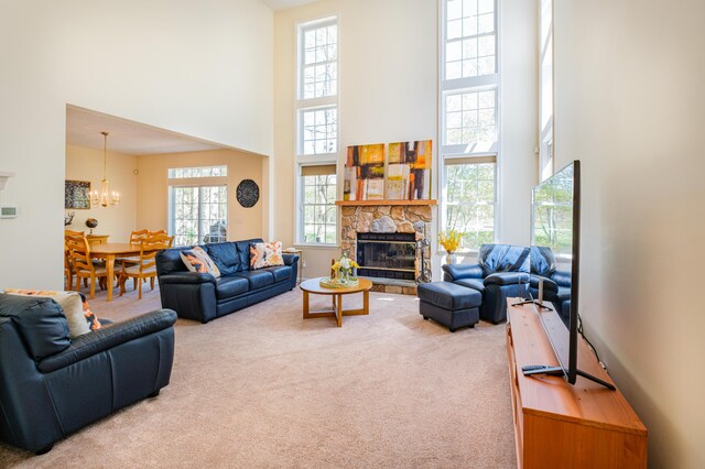 355 Windy Bush Rd, Pocono Pines, PA 18350 - carpeted living room with a high ceiling, a fireplace, and a chandelier