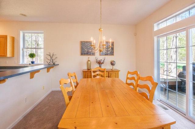 355 Windy Bush Rd, Pocono Pines, PA 18350 - carpeted dining area featuring baseboards and a chandelier