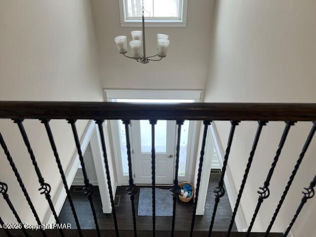 stairway featuring an inviting chandelier