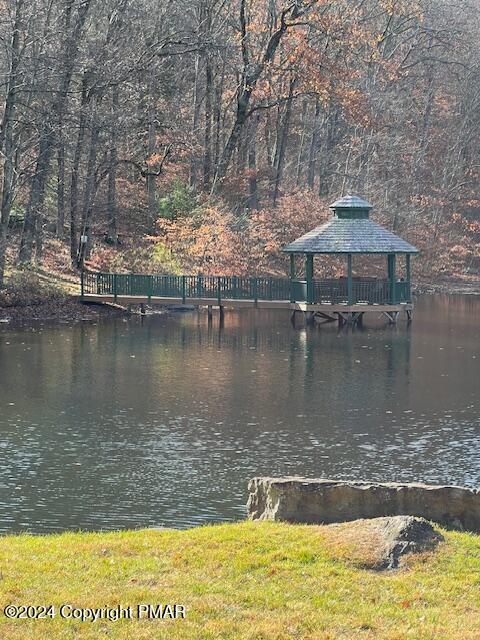 dock area with a gazebo and a water view