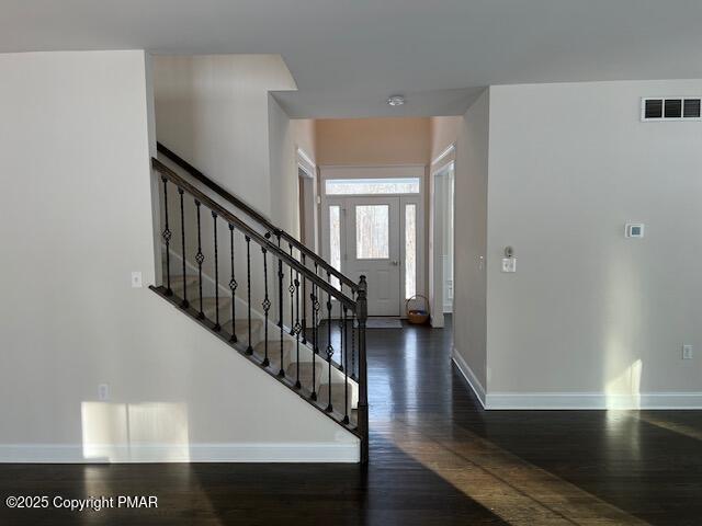 entryway with dark wood-type flooring