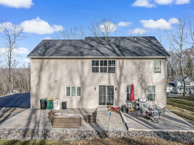 back of property featuring a patio area and outdoor lounge area