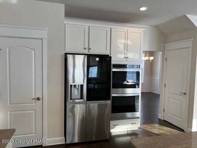 kitchen featuring white cabinetry, appliances with stainless steel finishes, and dark hardwood / wood-style floors