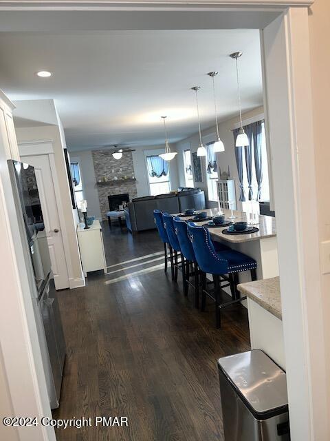 dining area with dark hardwood / wood-style floors and a fireplace