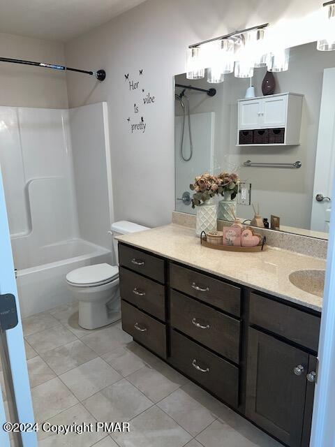 full bathroom featuring vanity, tile patterned floors, washtub / shower combination, and toilet