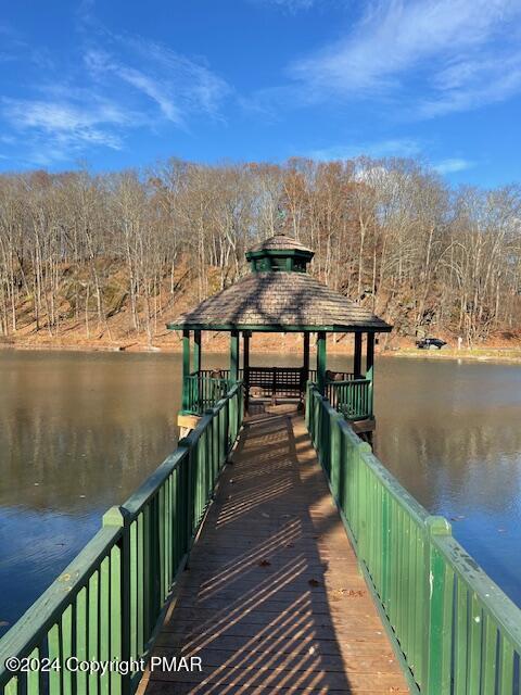 view of dock featuring a gazebo and a water view