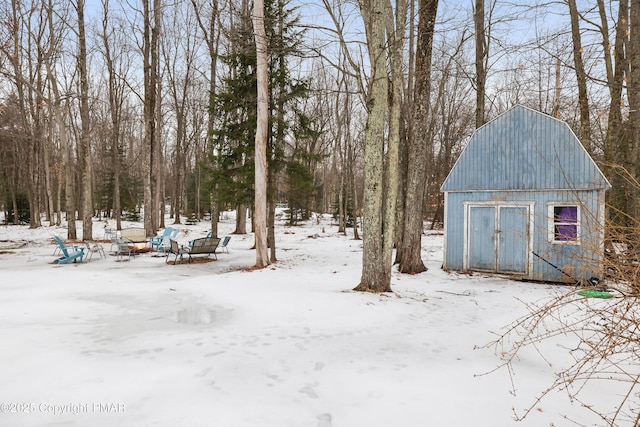 yard covered in snow featuring an outdoor structure