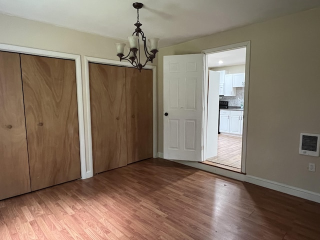 171 Linden Loop, Pocono Summit, PA 18346 - unfurnished dining area with a chandelier and light wood-style floors