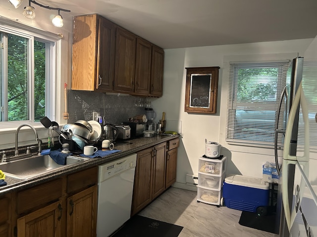22 Quay Ave, Mount Pocono, PA 18344 - kitchen featuring white dishwasher, backsplash, dark countertops, and plenty of natural light