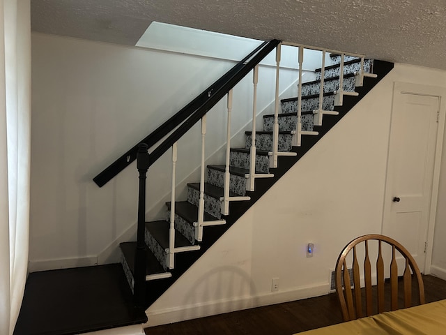 22 Quay Ave, Mount Pocono, PA 18344 - staircase with wood finished floors and a textured ceiling