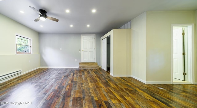 empty room with dark wood finished floors, recessed lighting, baseboard heating, ceiling fan, and baseboards