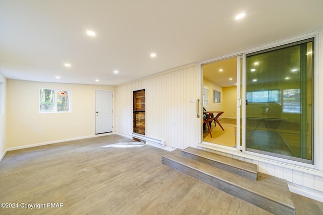 spare room with recessed lighting, baseboards, and wood finished floors