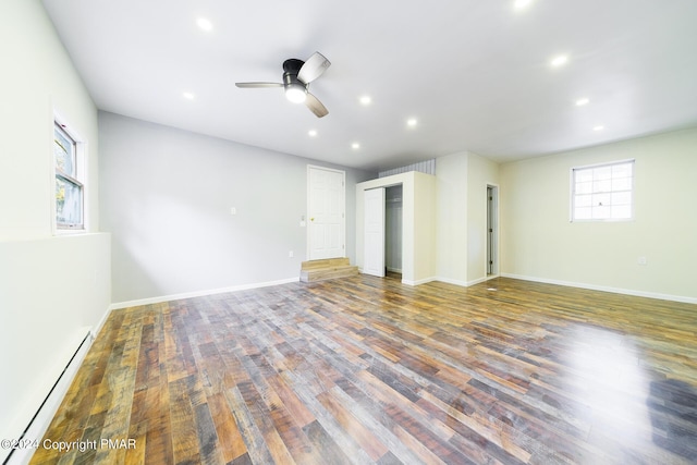 unfurnished bedroom featuring baseboards, a ceiling fan, wood finished floors, baseboard heating, and recessed lighting