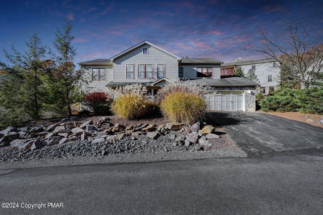 view of front of house featuring aphalt driveway and an attached garage