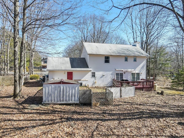 34 Heath Ln, Mount Pocono, PA 18344 - back of property featuring a chimney and a deck