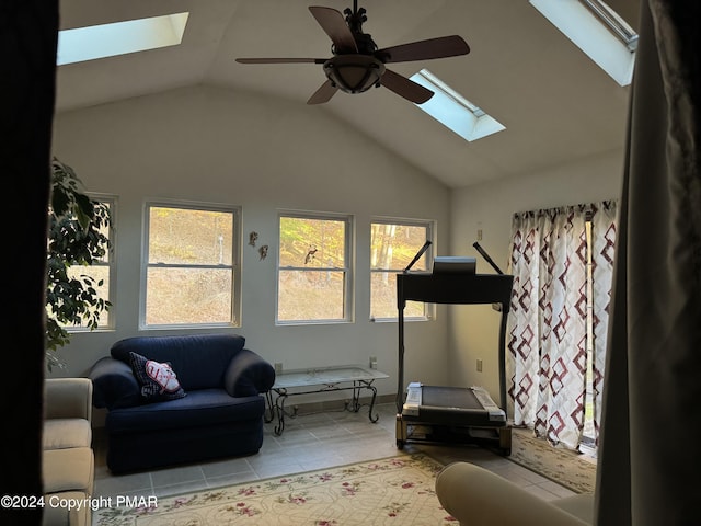 workout area with ceiling fan, plenty of natural light, vaulted ceiling, and tile patterned floors