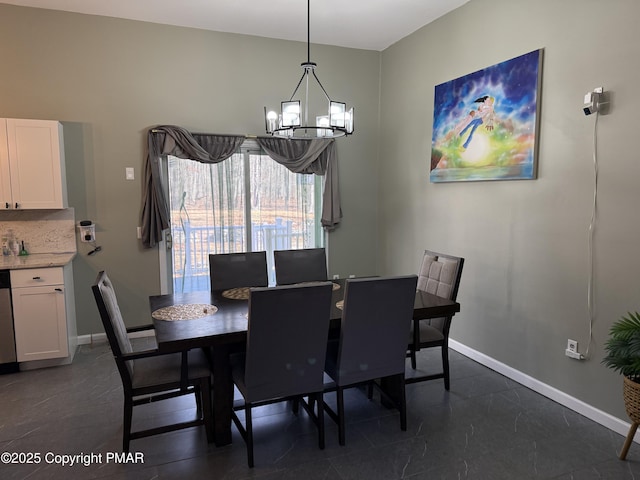 dining space with a chandelier and baseboards