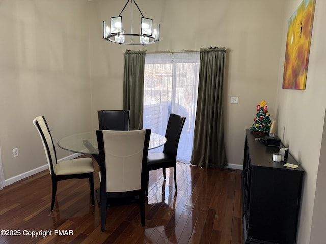 dining room with dark wood-type flooring, baseboards, and an inviting chandelier