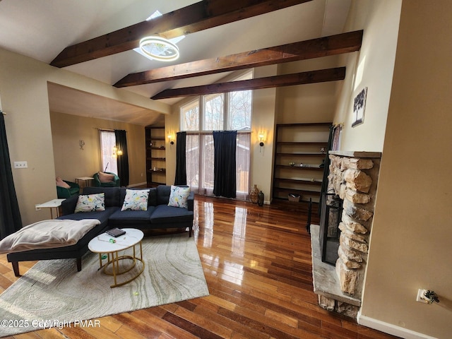 living room featuring a fireplace, hardwood / wood-style floors, and vaulted ceiling with beams