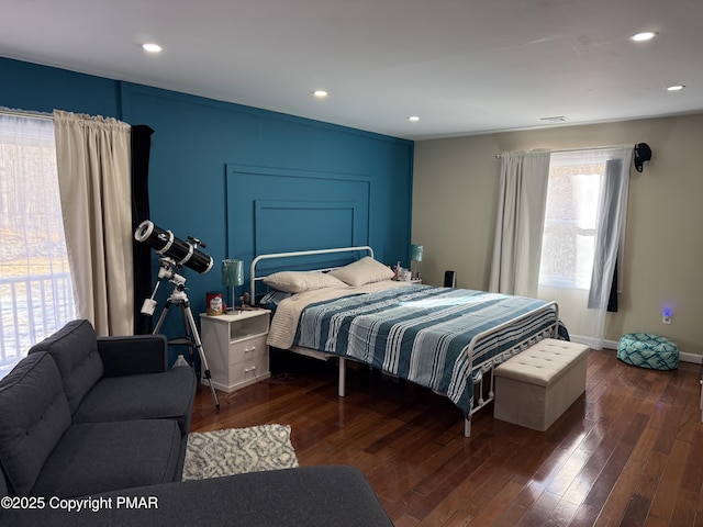 bedroom featuring baseboards, hardwood / wood-style flooring, and recessed lighting