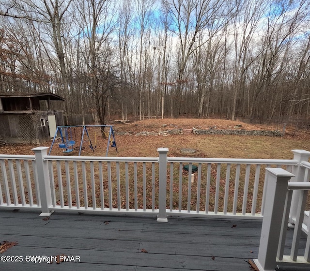 wooden deck featuring a playground