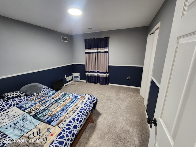 carpeted bedroom featuring visible vents and baseboards