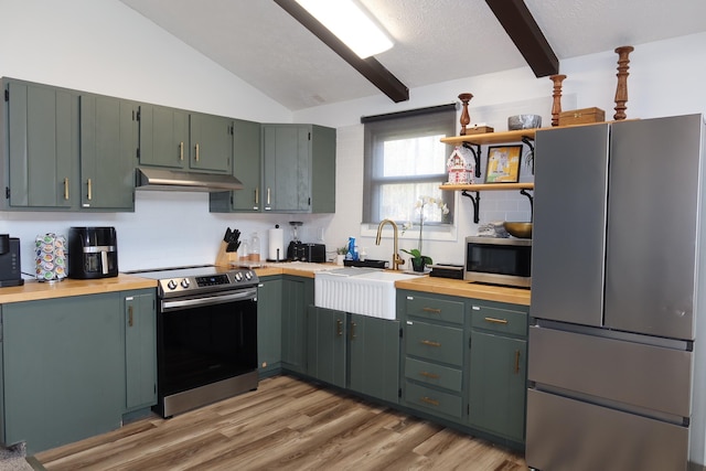 5306 Ledgewood Dr, Tobyhanna, PA 18466 - kitchen with a sink, under cabinet range hood, backsplash, appliances with stainless steel finishes, and butcher block counters
