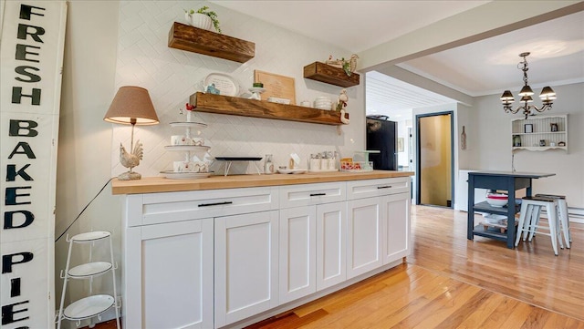 106 Silver Ln, Cresco, PA 18326 - kitchen featuring light wood-type flooring, wooden counters, white cabinetry, backsplash, and decorative light fixtures