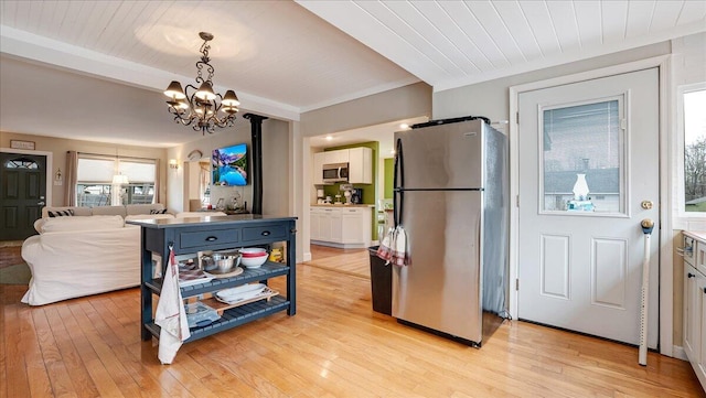 106 Silver Ln, Cresco, PA 18326 - kitchen featuring stainless steel appliances, a chandelier, light wood finished floors, hanging light fixtures, and wooden ceiling with exposed beams