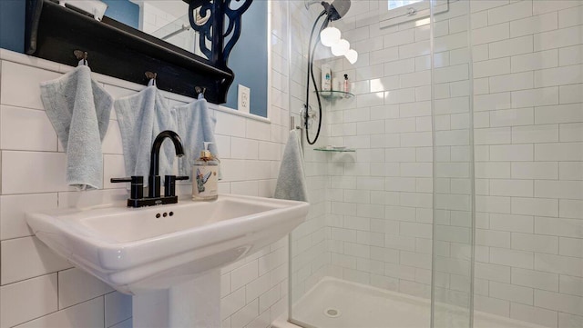 106 Silver Ln, Cresco, PA 18326 - bathroom featuring a stall shower, tile walls, and a sink