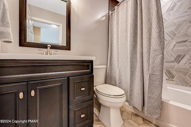 full bath with toilet, shower / bath combo, and vanity