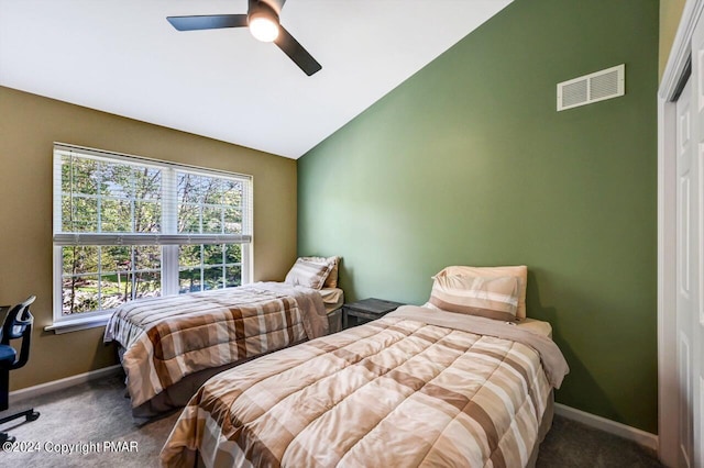 bedroom with carpet, visible vents, vaulted ceiling, and baseboards