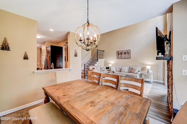 dining area featuring a notable chandelier, recessed lighting, wood finished floors, baseboards, and stairs