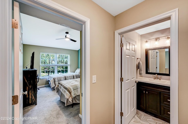 bathroom with vanity, baseboards, and ensuite bathroom