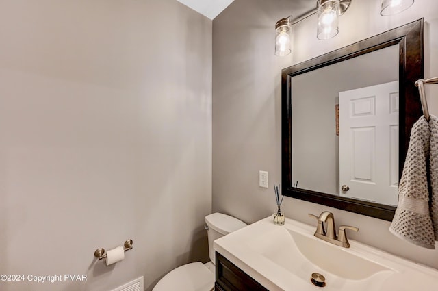 bathroom with toilet and vanity